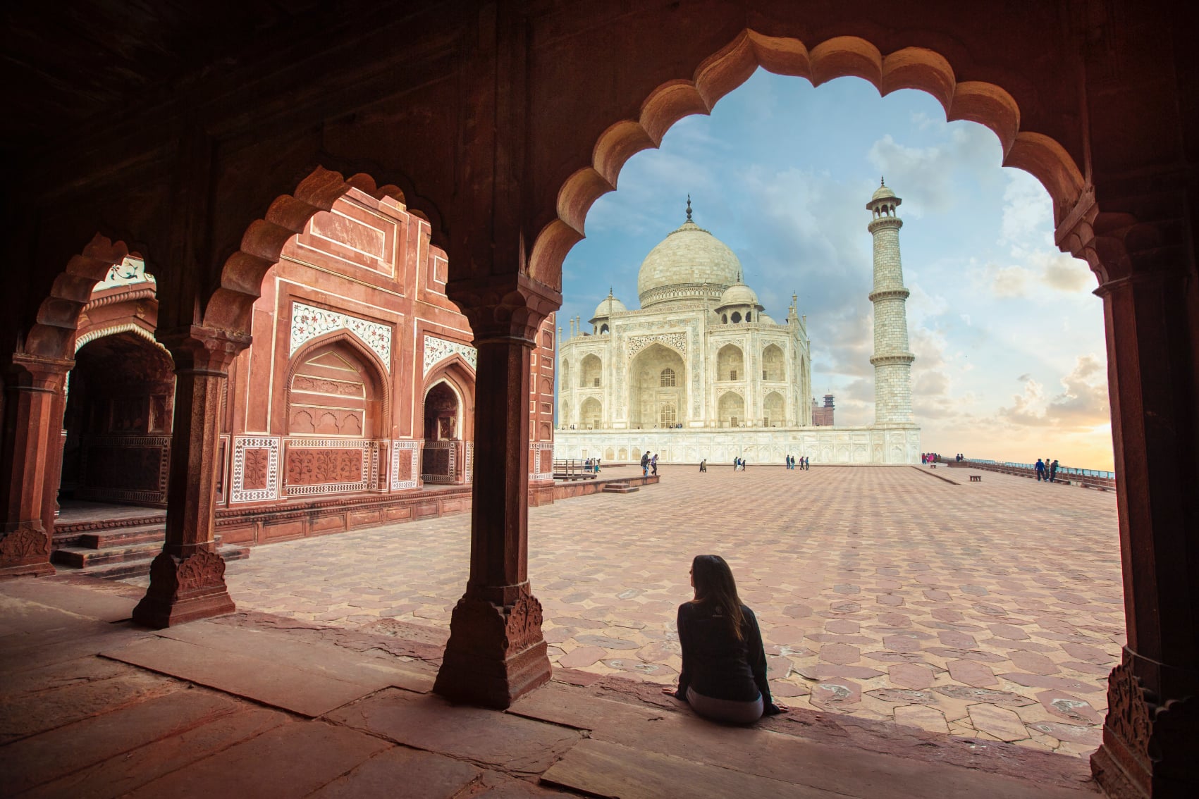 Taj Mahal arches Traveller sitting under the ornate arches of Agra's Taj Mahal