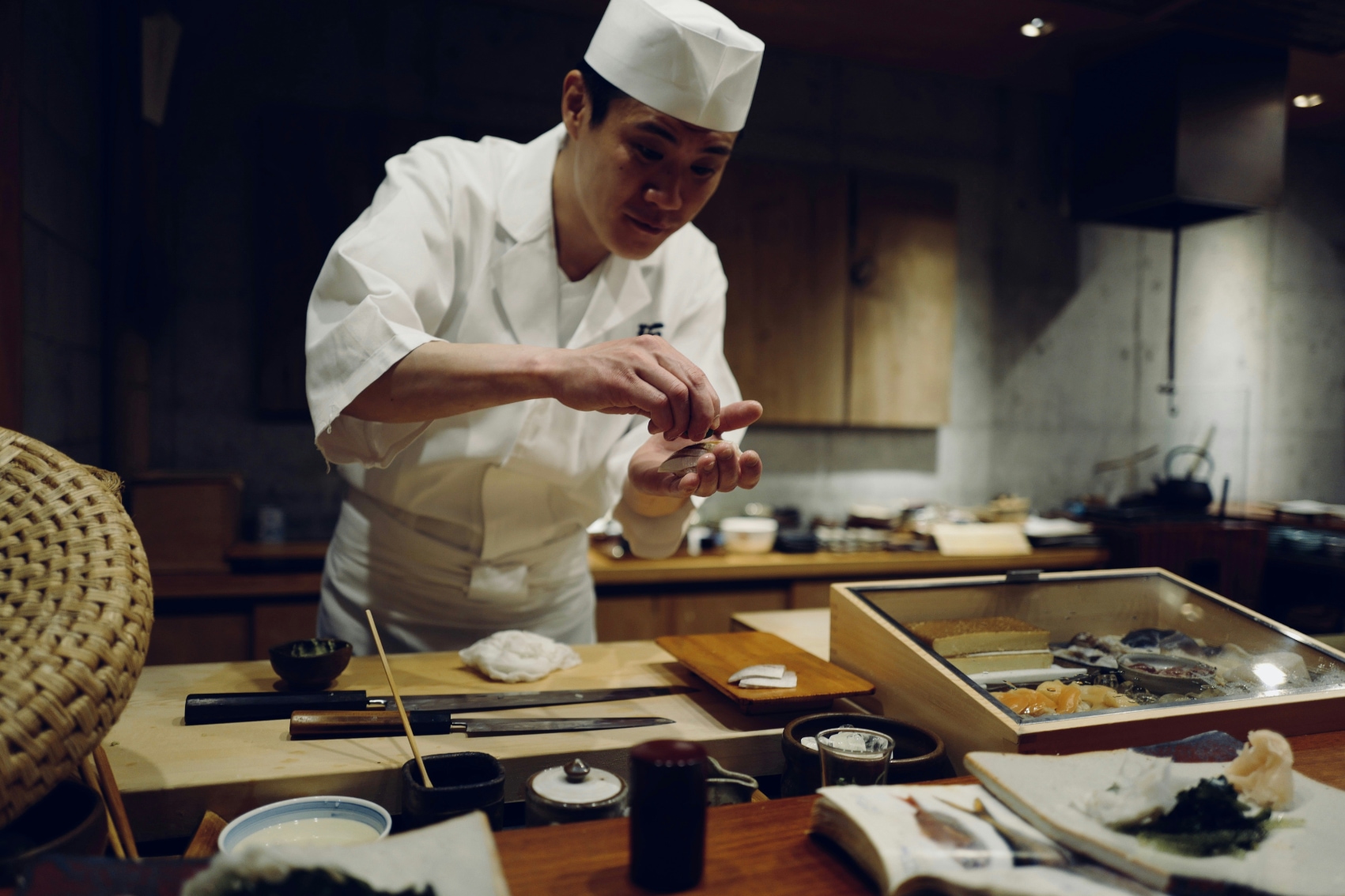 Sushi chef A sushi chef carefully preparing nigiri for a traveller