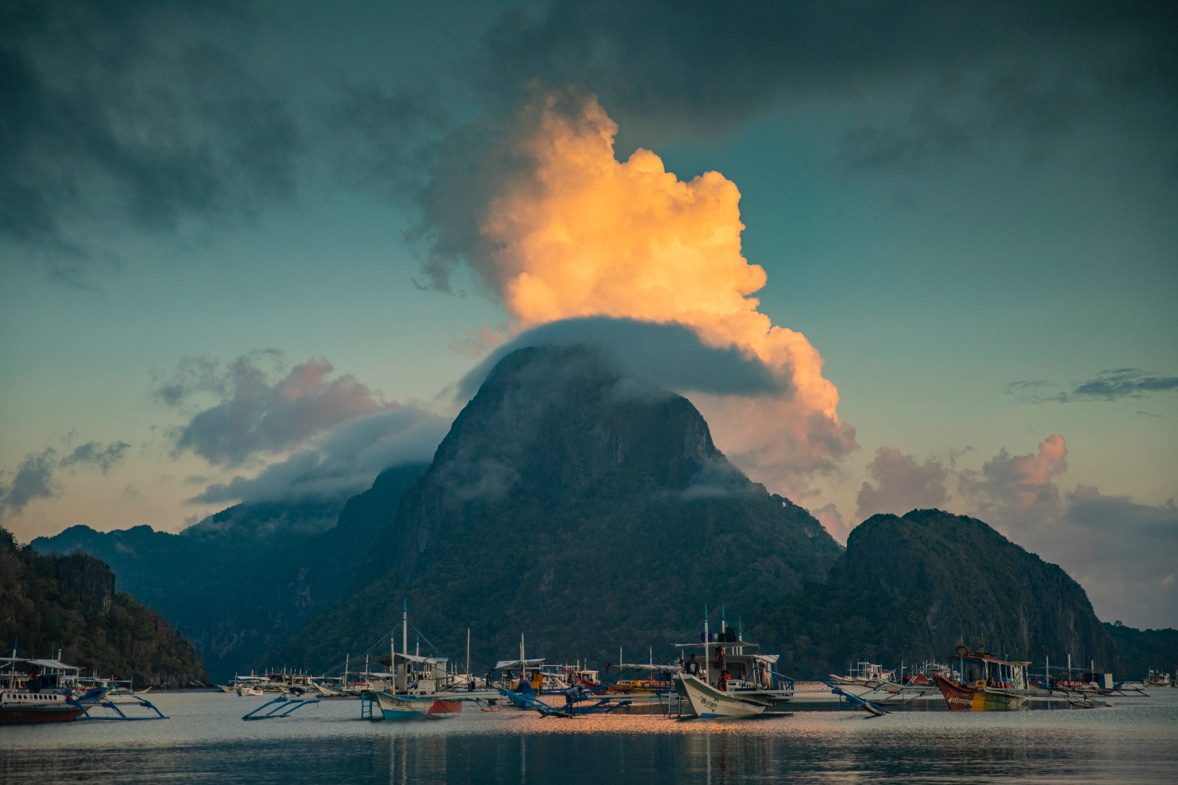 mountain sunset philippines a giant cloud lit up by the sunset over the mountain beach in the Philippines
