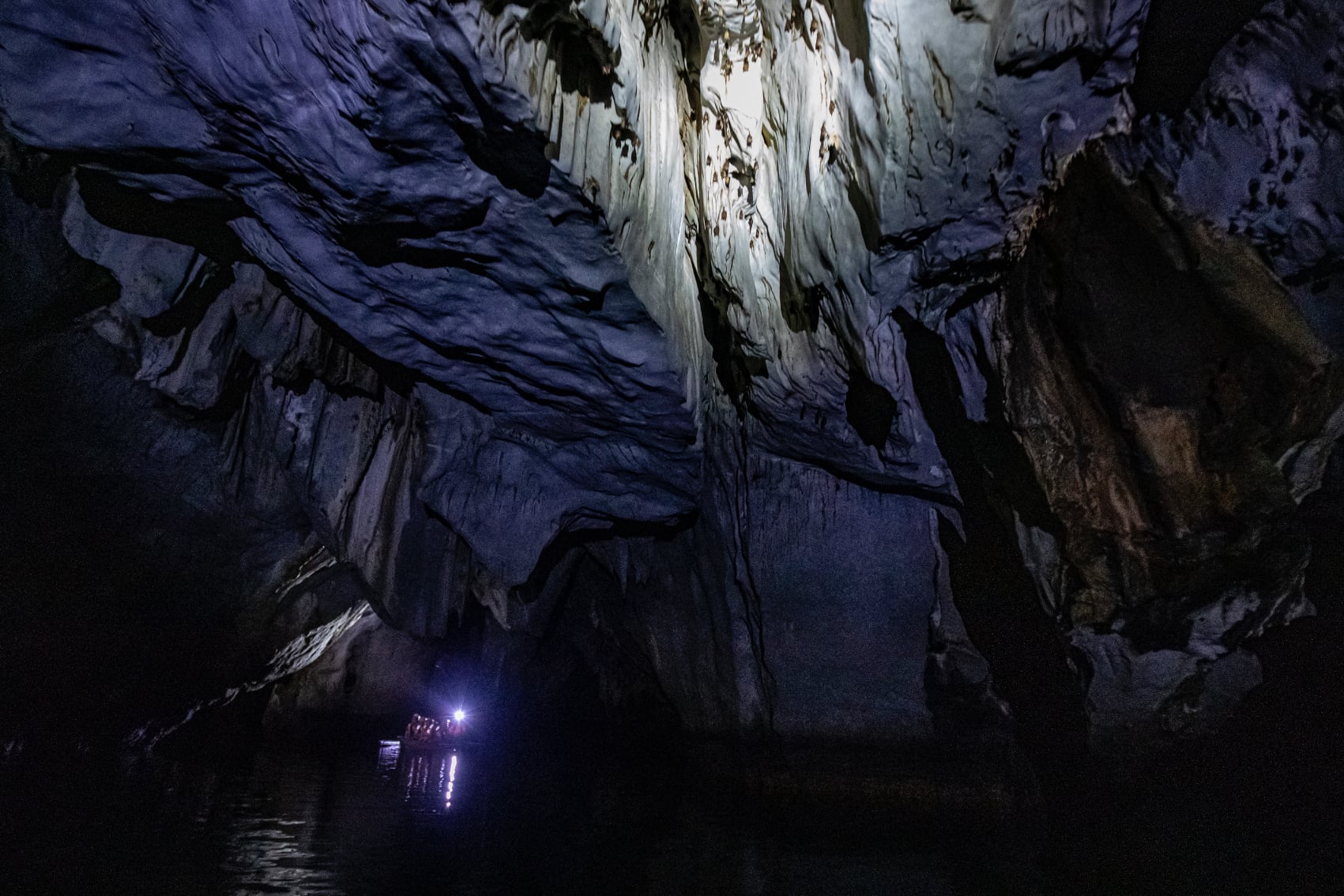 underground river cruise a lamplit boat cruises the caverns of the underground river in Palawan